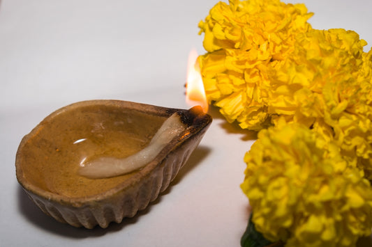 a candle is lit next to a flower arrangement