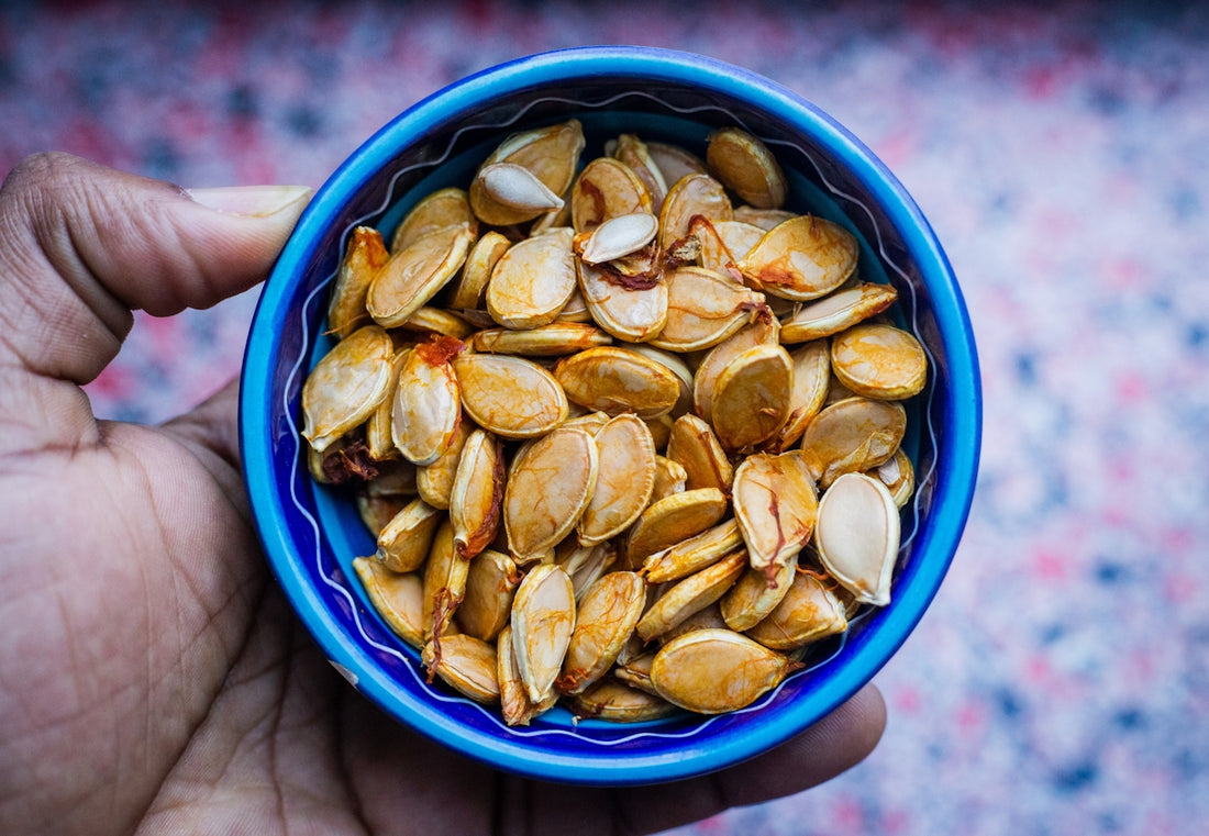 squash seeds in round blue bowl