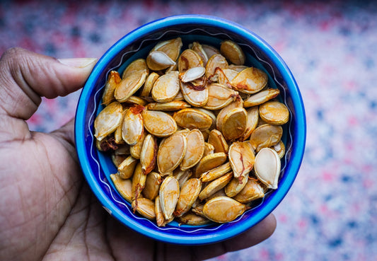 squash seeds in round blue bowl